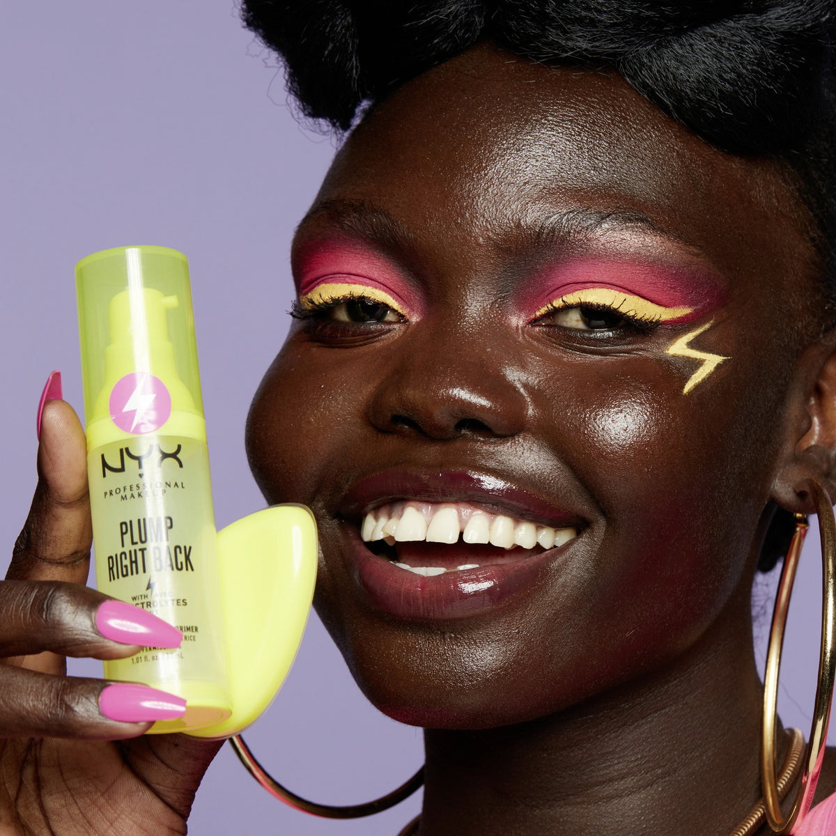 NYX Plump Right Back Plumping Serum and Primer bottle with silicone applicator held by model