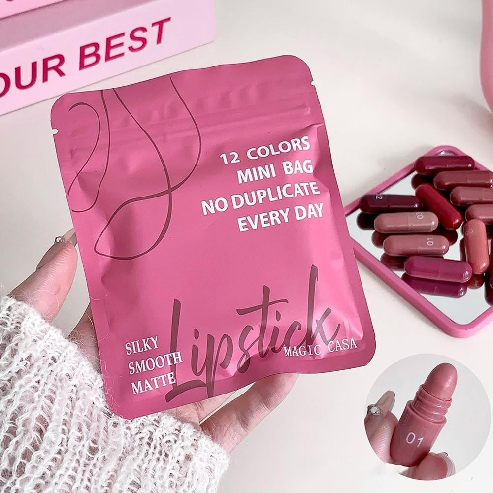 Magic Casa 12 Colors Mini Bag Lipstick Set - Silky Smooth Matte Capsule Lipsticks, Pink Pouch - Buy Online in Pakistan at Cosmia.pk - pink pouch held in hand with capsule lipsticks on a mirror tray