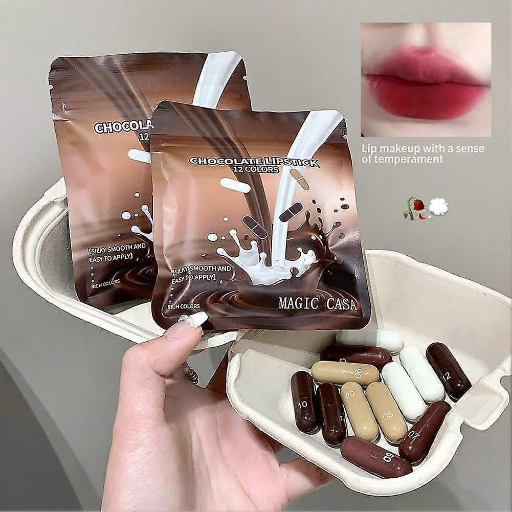 KS One Chocolate Lipstick Set - 12 Colors Mini Capsule Lipsticks, Silky Smooth (Treasure Mini Lipstick) - Buy Online in Pakistan at Cosmia.pk - two chocolate lipstick pouches with capsules in a gift tray