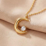 Gold moon pendant necklace close-up - round zircon inlaid in crescent moon