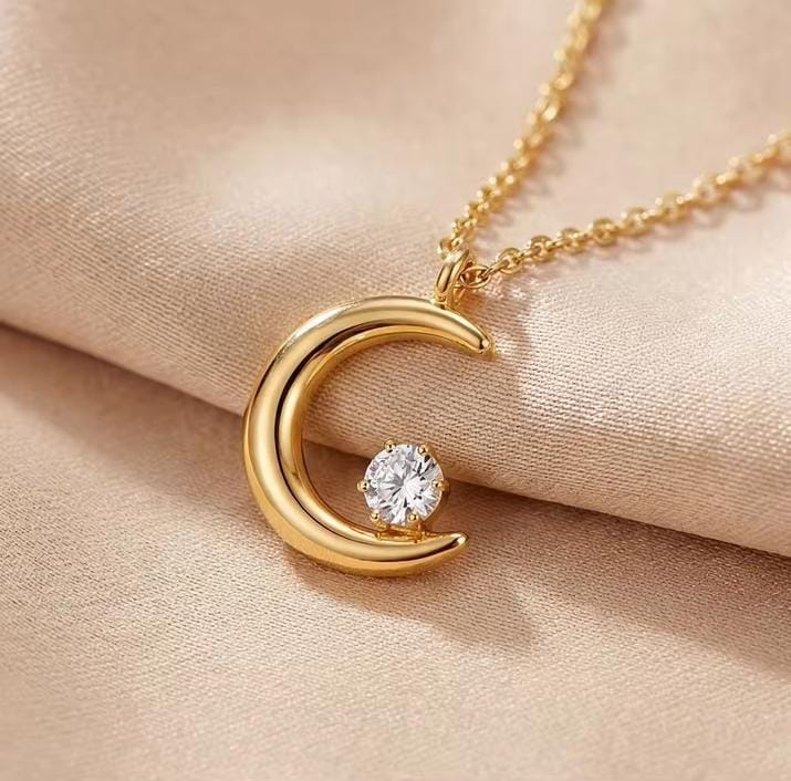Gold moon pendant necklace close-up - round zircon inlaid in crescent moon