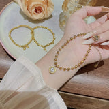 gold beaded ball chain bracelet with round zircon pendant - lifestyle shot