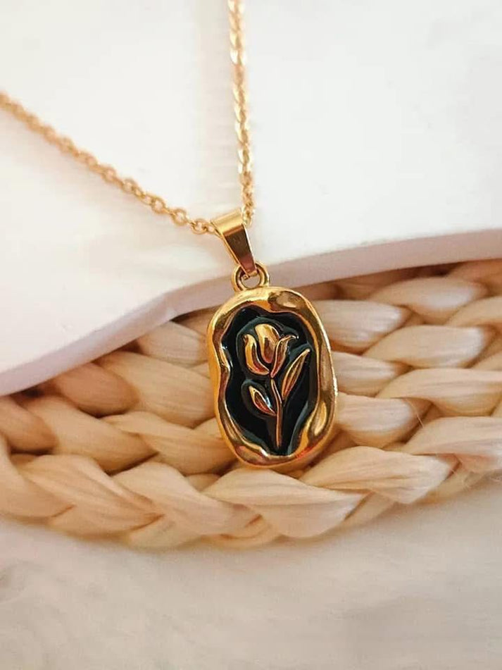 316L Stainless Steel Tulip Flower Pendant Necklace - Black enamel version, black enamel tulip pendant detail on woven rattan - buy online in Pakistan at Cosmia.pk