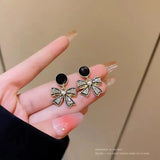Rhinestone Bow Black Round Stud - Buy Online in Pakistan at Cosmia.pk