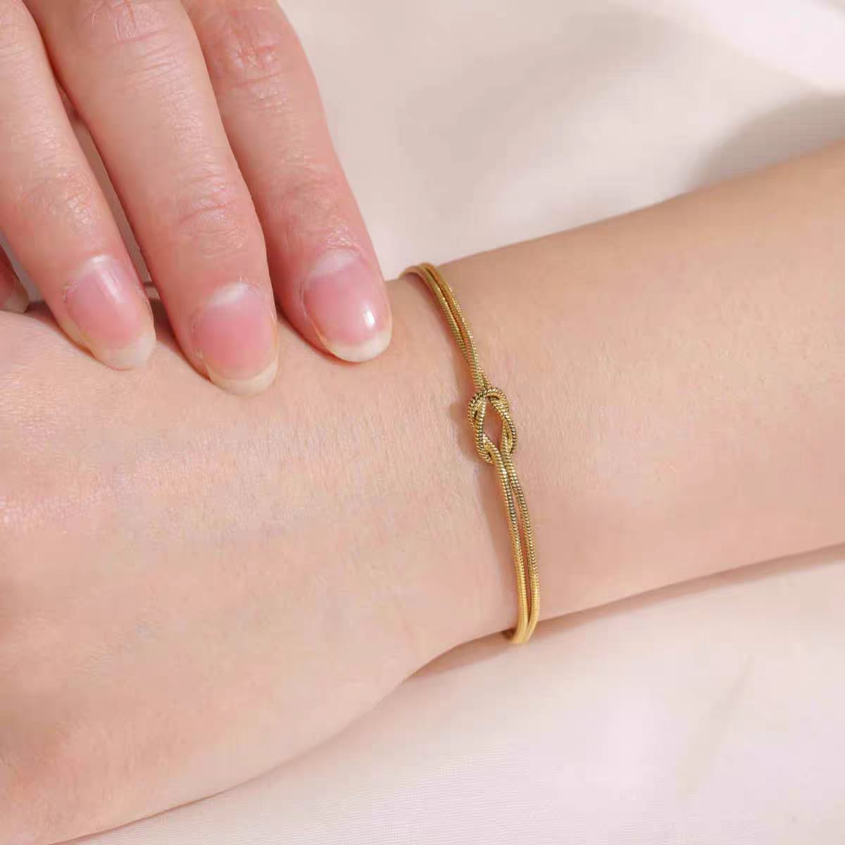 316L Stainless Steel Gold Love Knot Double Snake Chain Bracelet - close up of love knot