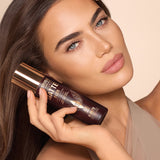 Model holding Charlotte Tilbury Airbrush Flawless Setting Spray Matte Blur - Buy Online in Pakistan at Cosmia.pk