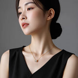 Cylinder zirconia pendant necklace for women worn with black top