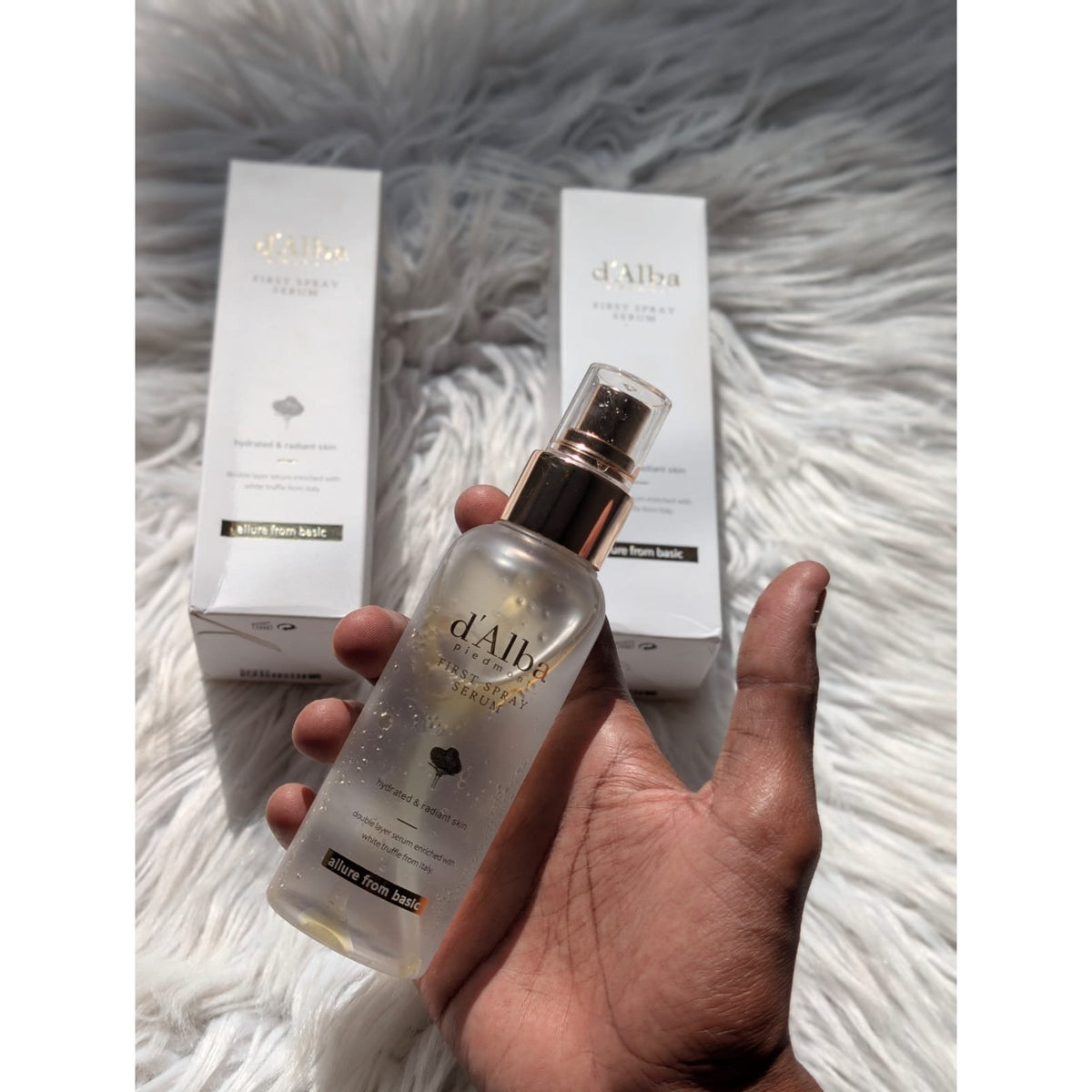d'Alba White Truffle First Spray Serum 100ml bottle held in hand with boxes