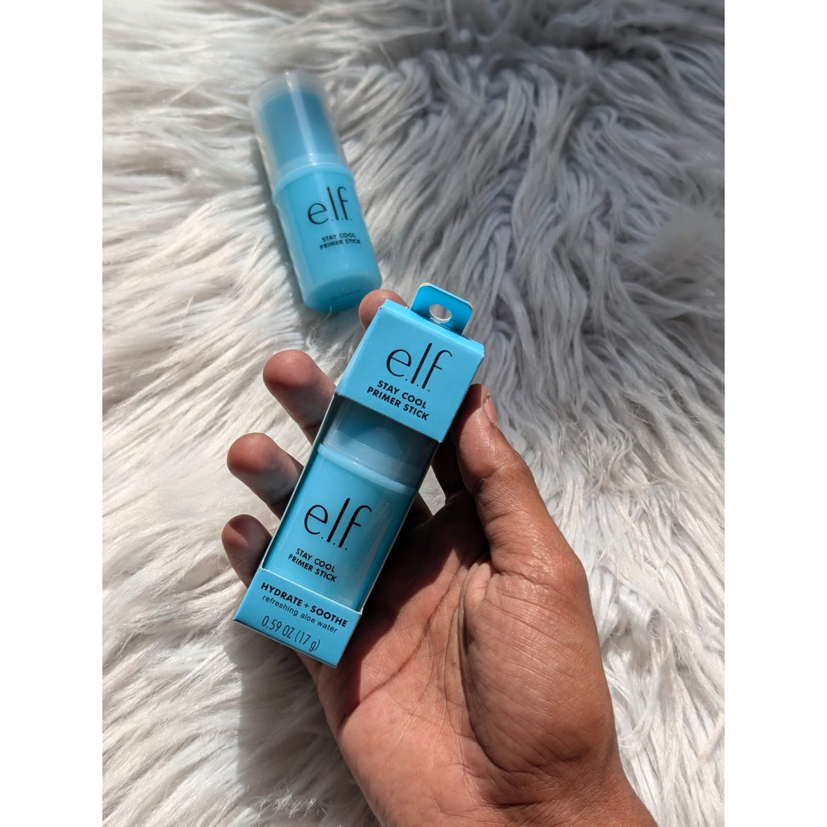 e.l.f. Stay Cool Primer Stick 17g box held in hand with loose primer stick on fur background
