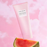 Glow Recipe Watermelon Glow Pink Dream Body Cream tube floating over fresh watermelon slice
