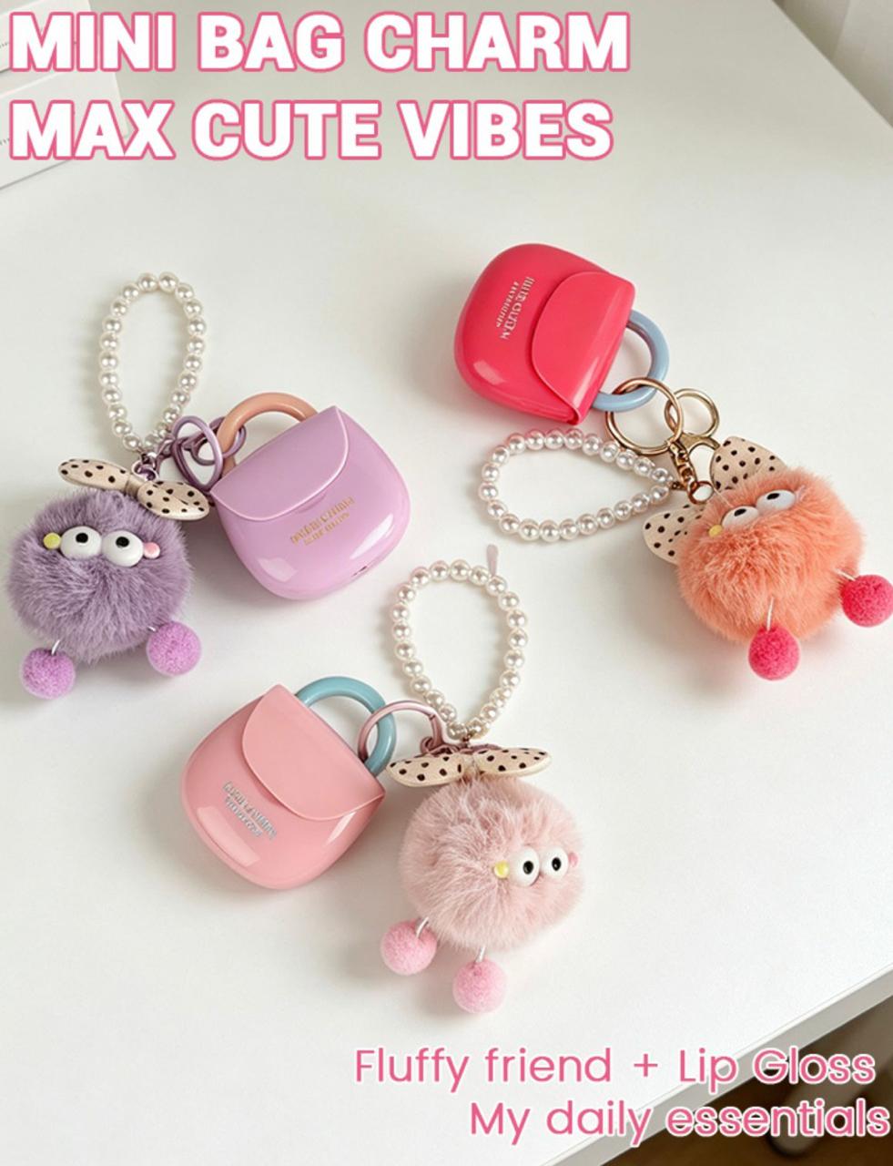 Hues Queen mini bag lip gloss purple pink red with fuzzy ball keychain