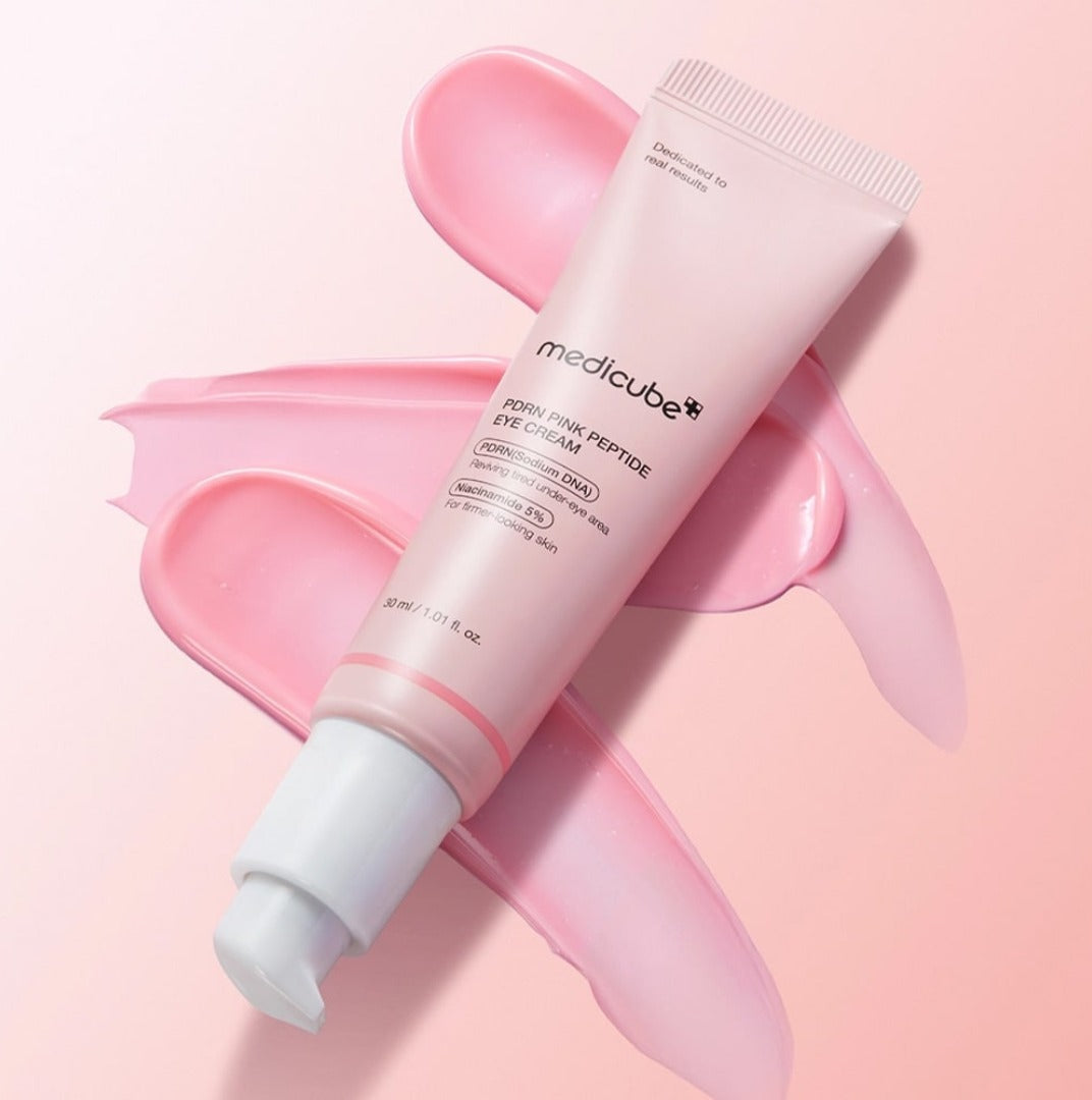 Medicube PDRN Pink Peptide Eye Cream 30ml — pink tube with cream swatches on pink background