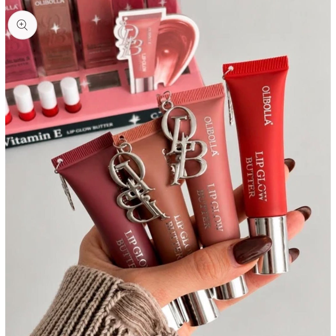 Olibolla Vitamin E Lip Glow Butter tubes held in hand with display