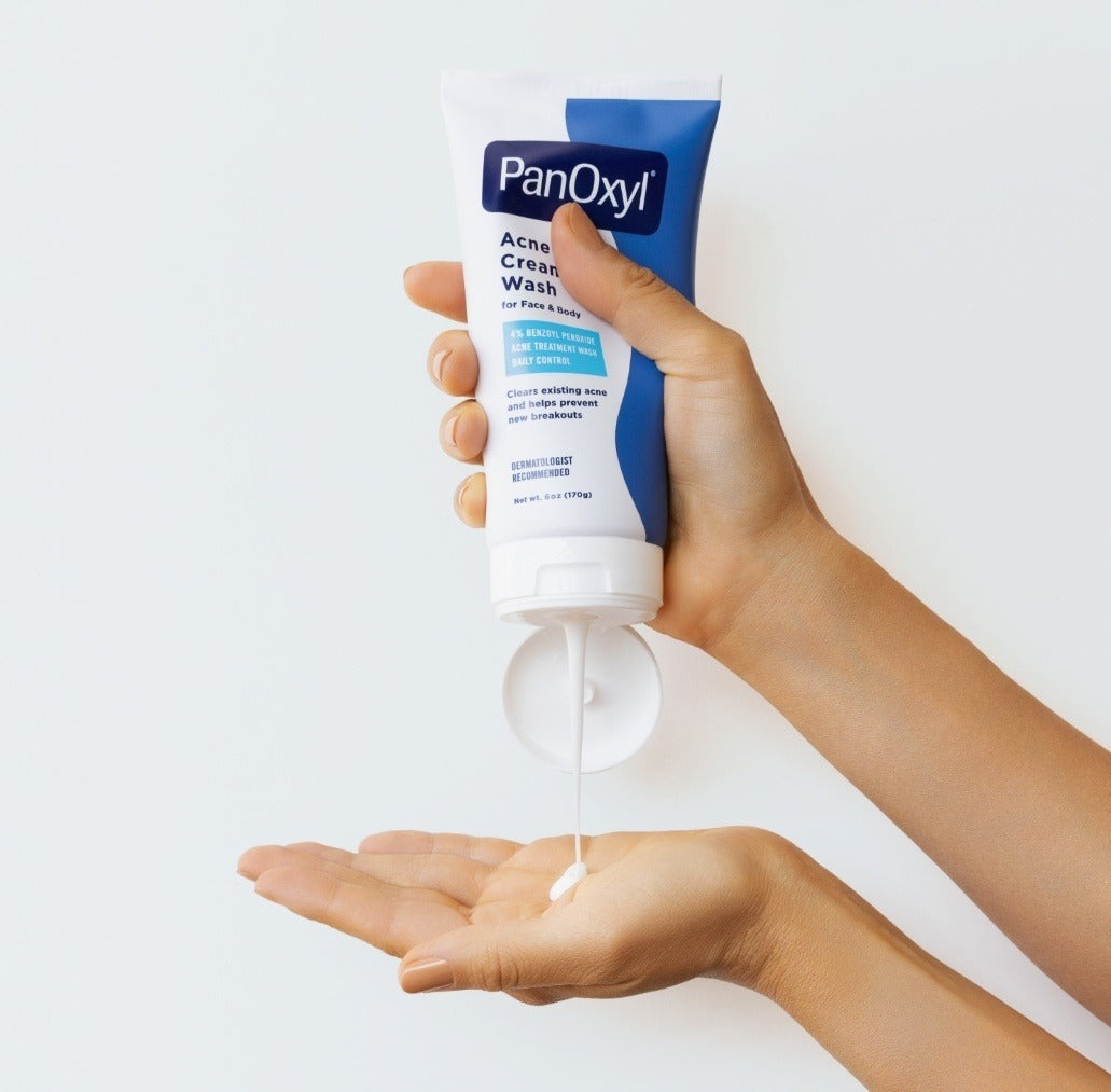 PanOxyl Acne Creamy Wash 4% Benzoyl Peroxide 170g – hand holding tube lifestyle shot