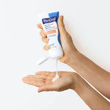 PanOxyl PM Balancing Repair Moisturizer with Niacinamide 85g – hand squeezing tube lifestyle shot