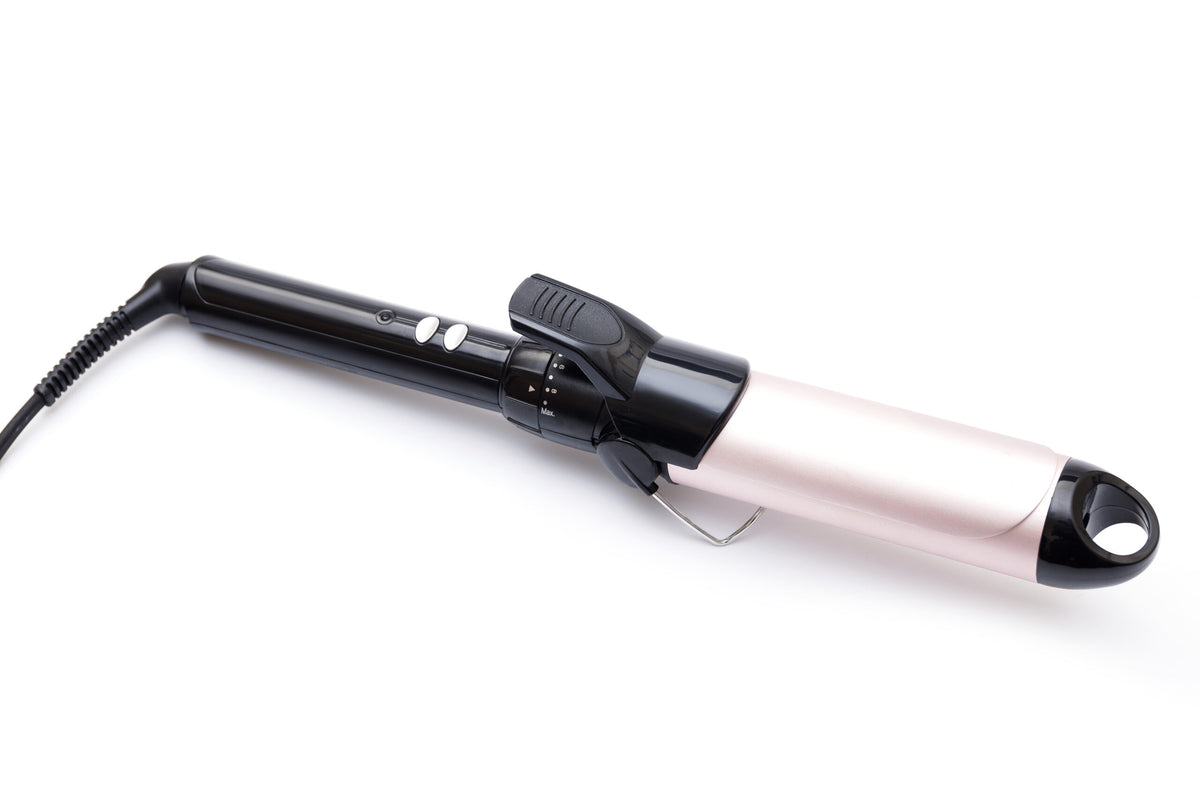 Professional hair curling iron on white background