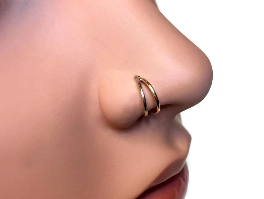 Stainless steel double hoop nose ring in silver polished finish worn on nostril
