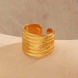 Stainless Steel Textured Wide Thick Golden Open Ring side view on beige stone - buy online in Pakistan at Cosmia.pk