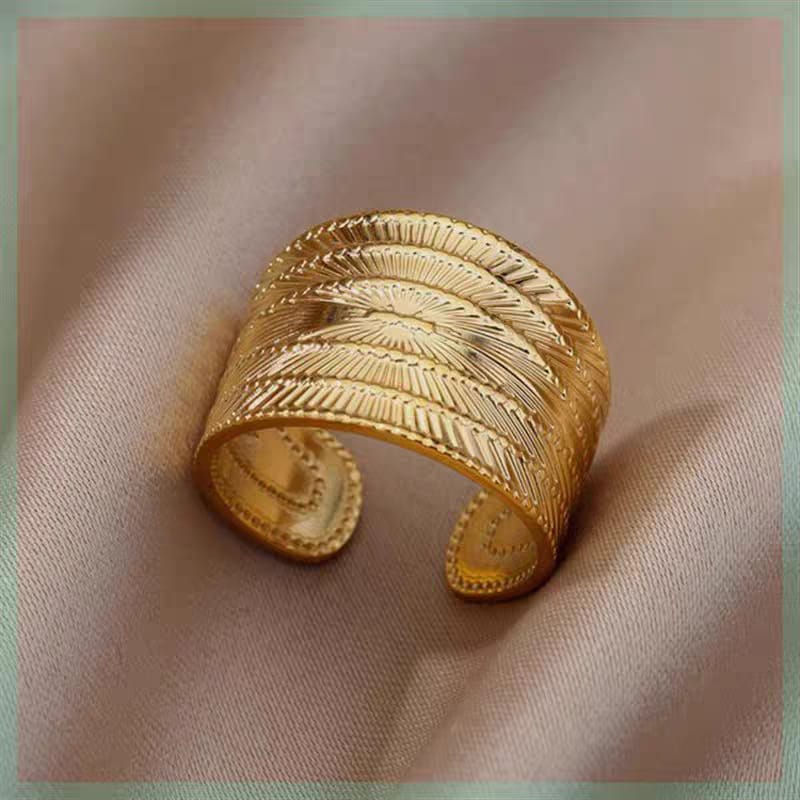 Stainless Steel Textured Wide Thick Golden Open Ring detail view on pink silk - buy online in Pakistan at Cosmia.pk